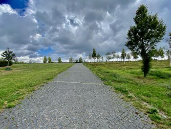 Road amidst trees against sky