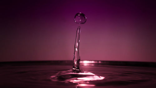 Close-up of drop falling on water