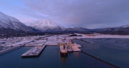 Aerial view of snowcapped mountains against sky during winter