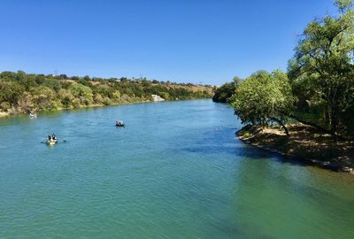 Scenic view of lake against clear blue sky