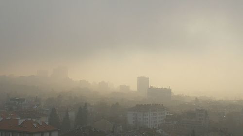 High angle view of buildings in city against sky