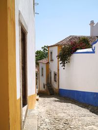 Street amidst houses on sunny day