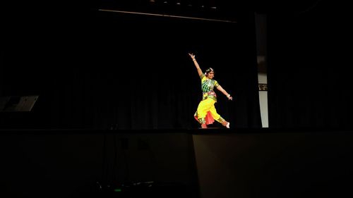 Young woman dancing by stage