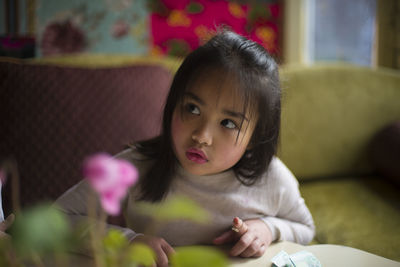 Portrait of girl sitting at table