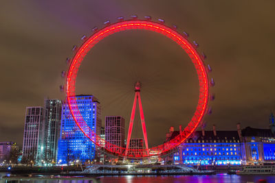 Illuminated ferris wheel at night