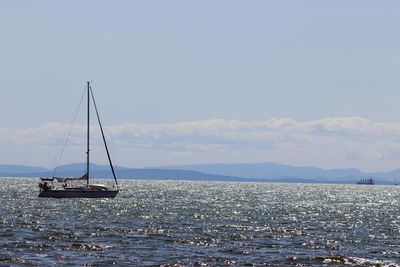 Sailboat on sea against sky