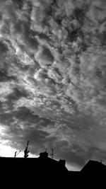 Low angle view of building against cloudy sky