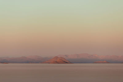 Scenic view of desert against sky during sunset