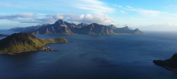 Panoramic view of sea and mountains against sky