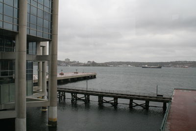 Scenic view of sea by building against sky