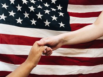 Cropped hands holding american flag