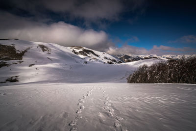 Scenic view of snowcapped mountains against sky