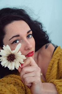 Portrait of woman holding flower