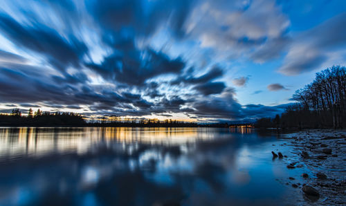 Scenic view of lake against sky at dusk