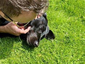 Close-up of man with dog on grass