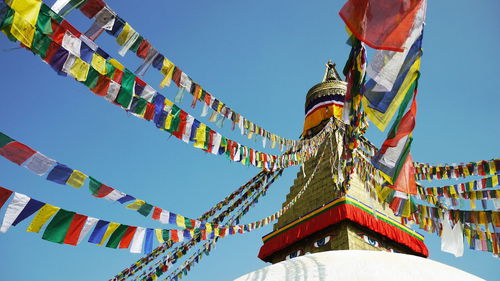 Low angle view of flags against clear sky