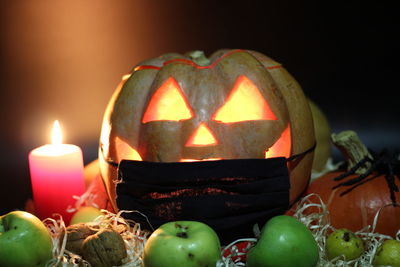 Close-up of illuminated pumpkin against black background