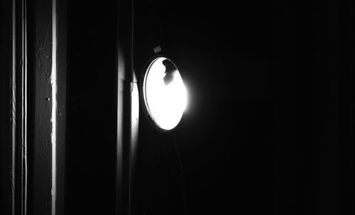 Low angle view of illuminated lamp against sky at night