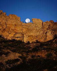 Idyllic shot of full moon over cliff at red rock canyon open space