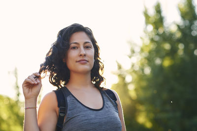 Portrait of a young woman in the field doing a hiking trail