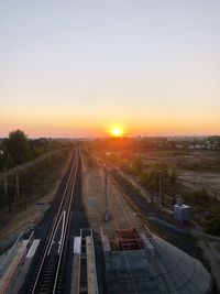 High angle view of railroad tracks against sky during sunset