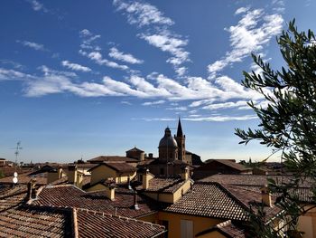 Buildings in town against sky