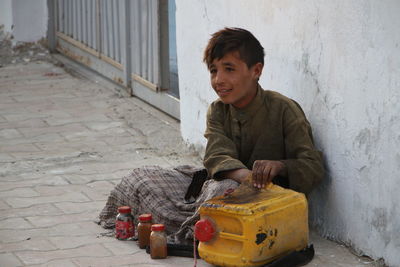 A poor shoeshiner boy trying to make a living by cleaning and shining shoes.