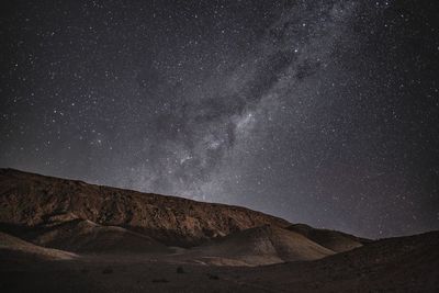 Scenic view of mountain against sky at night