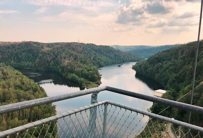 High angle view of river amidst trees against sky