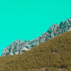 Scenic view of mountains against clear blue sky