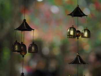 Close-up of illuminated pendant lights hanging from ceiling