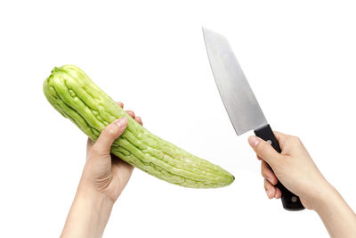 Midsection of man holding ice cream against white background