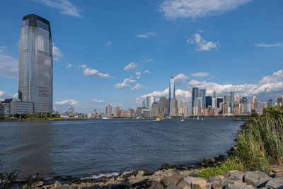 View of buildings by sea against sky