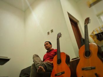 Low angle view of man playing guitar