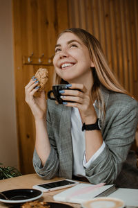 Young woman sitting on table