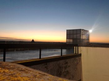 Pier on sea at sunset