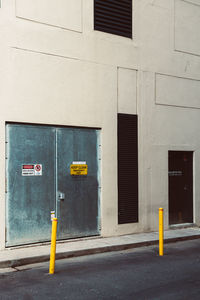 Yellow sign on building by street