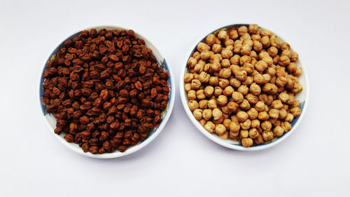 Directly above shot of coffee beans against white background