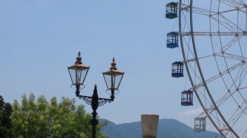 Low angle view of street light against blue sky