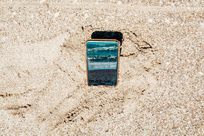 High angle view of old telephone booth on beach