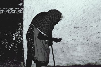 Woman standing by railing