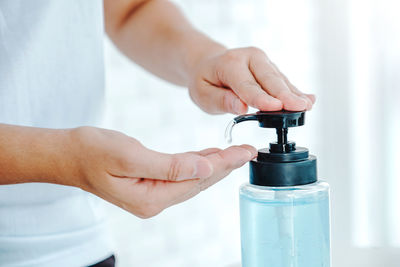 Close-up of human hand holding bottle