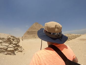 Rear view of woman standing against sky