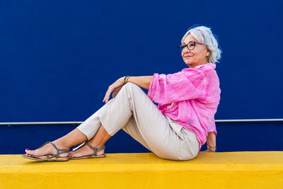 Portrait of young woman sitting on field