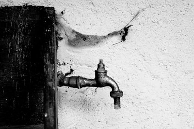 Old faucet against wall