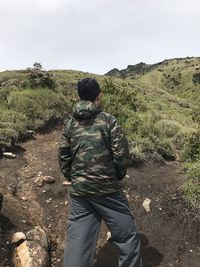 Rear view of man on landscape against sky