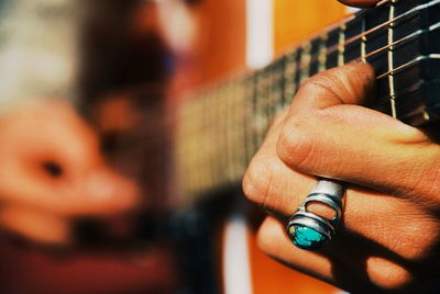 Close-up of hand playing guitar