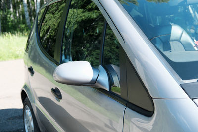 Reflection of car on side-view mirror