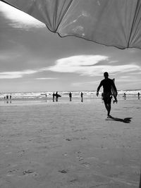 People on beach against sky