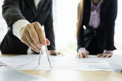 Close-up of people working on table